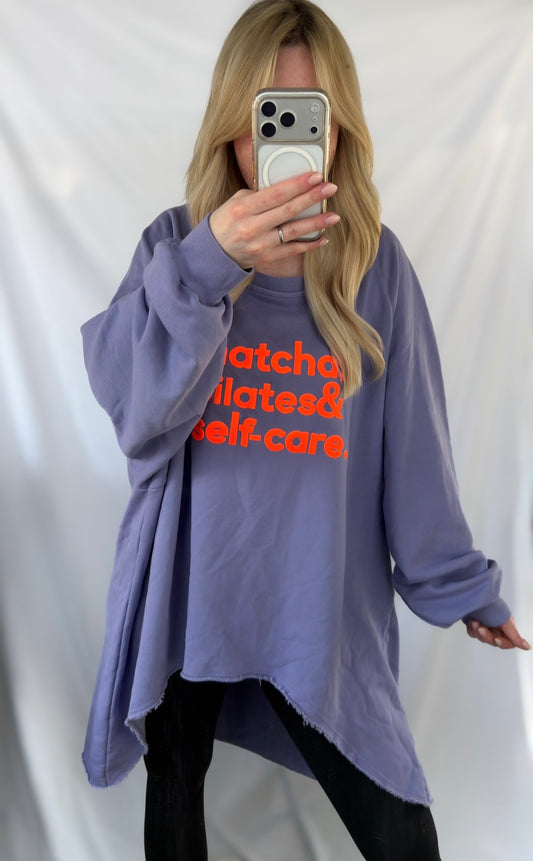 Lila Vokuhila Sweatshirt von Feinraummode für Pilates und Selbstfürsorge, bequem und stylisch, auf einem klaren Hintergrund.