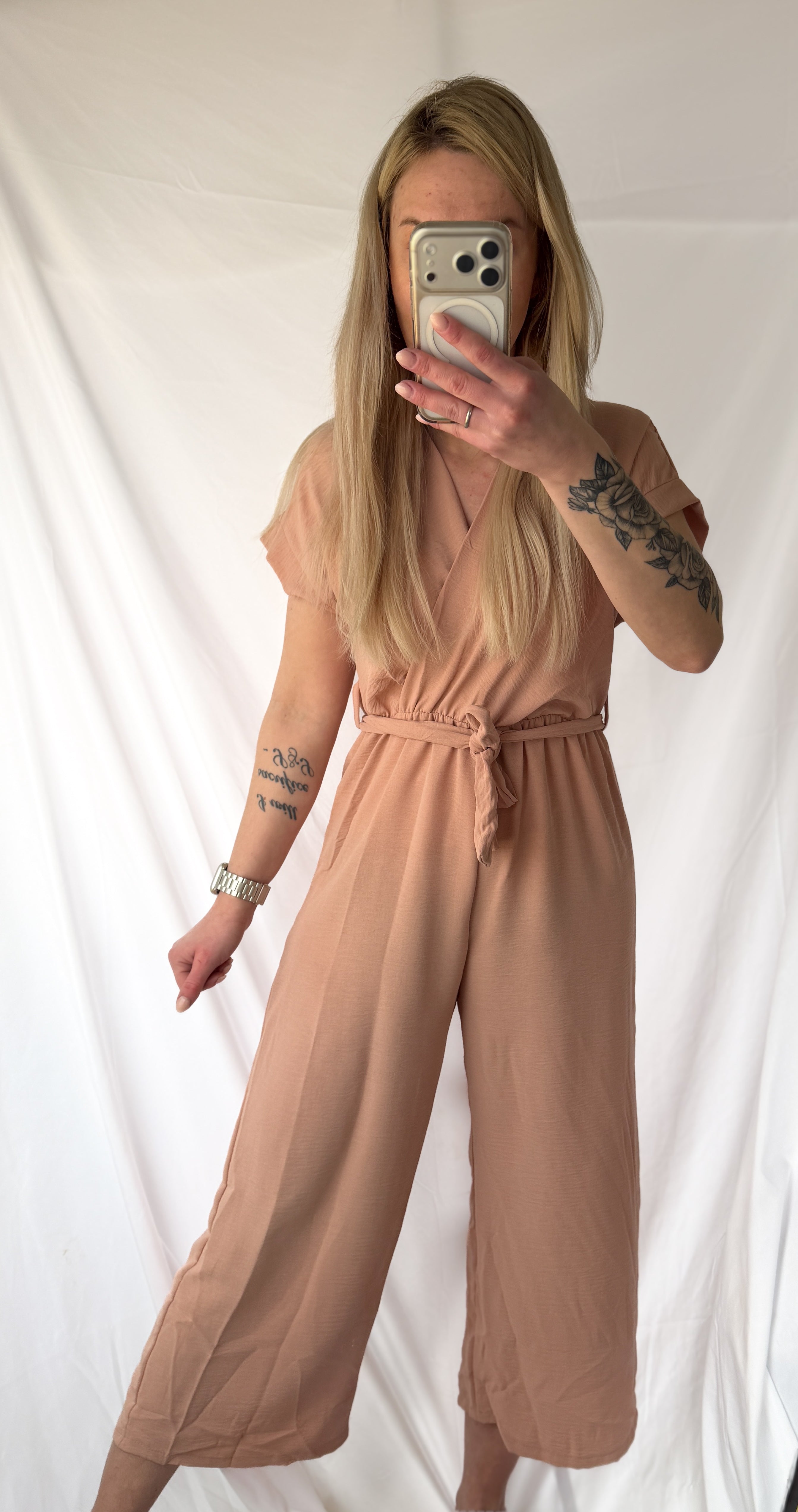 Lockerner rosa Jumpsuit von Feinraummode, blickdichtes Design, mit weiten Beinen und bequemem Schnitt, auf weißem Hintergrund.
